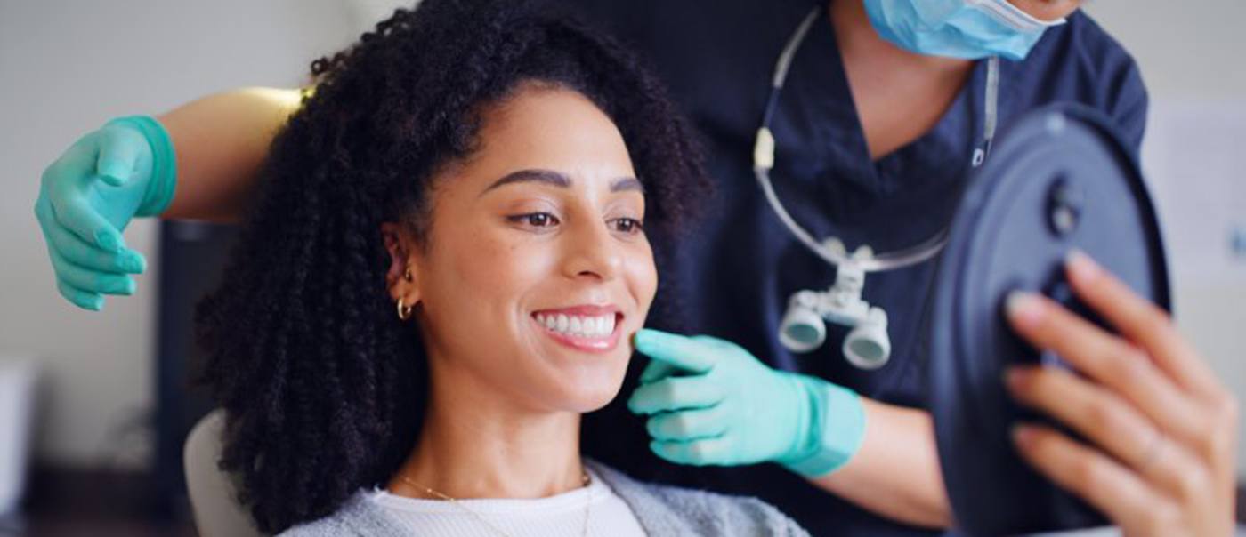 a patient with straight teeth visiting her orthodontist