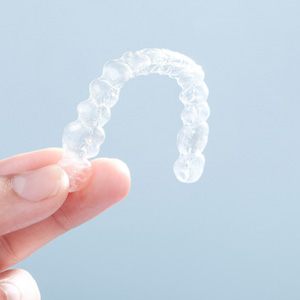 Patient holding clear aligner