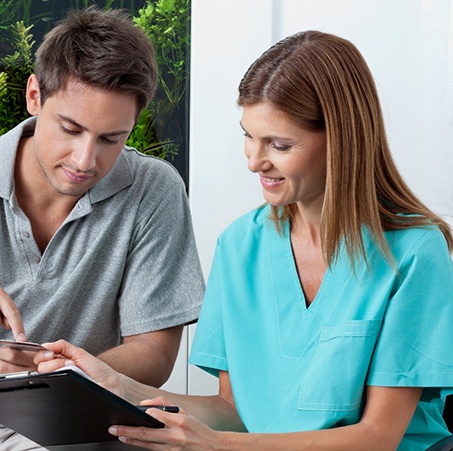 A man paying for orthodontic treatment