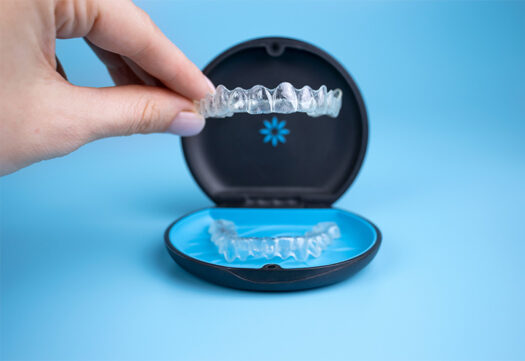 Person holding Invisalign.