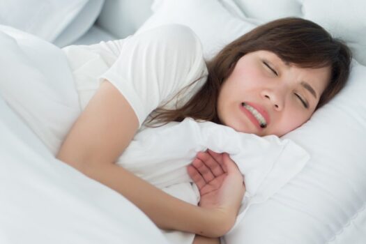 Woman grinding her teeth while asleep.