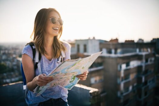 Woman traveling and holding a map.