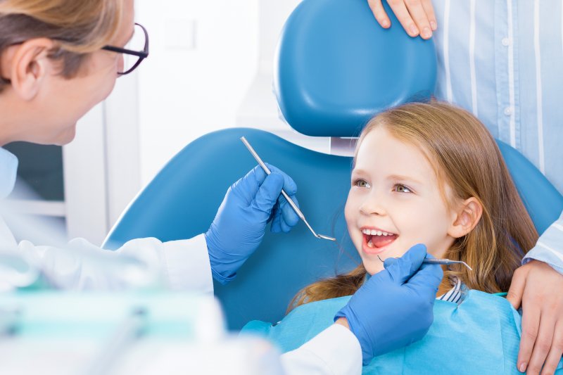 Child smiles at dentist