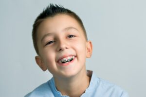 Child smiling with braces.
