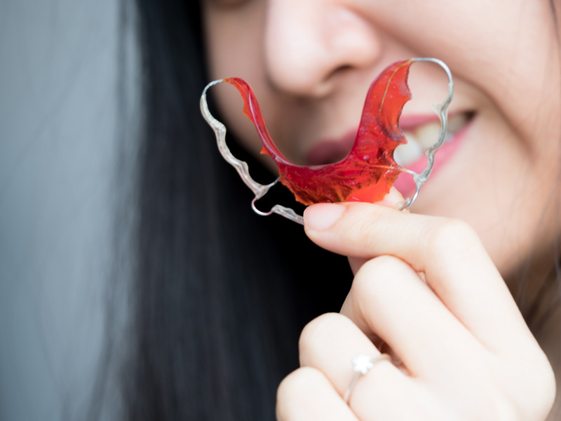 Patient smiling with retainer after braces
